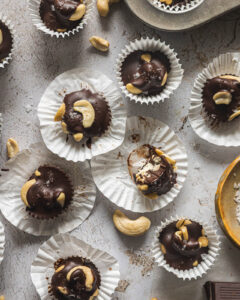 Homemade dark chocolate cashew clusters with whole cashews and flaky sea salt