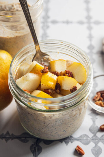 High protein overnight oats topped with chopped pear and pecans