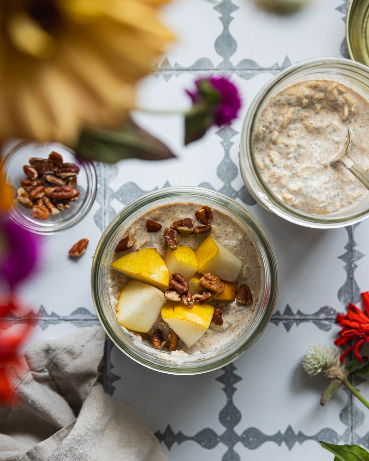 Two jars of pear overnight oats with pecans