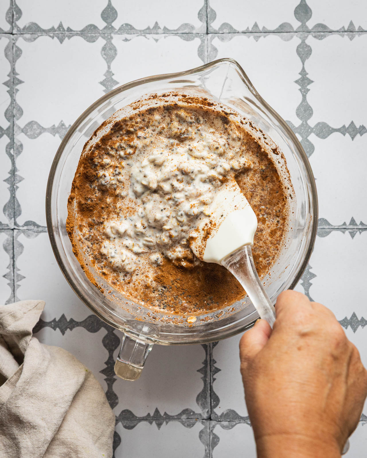 Stirring Greek yogurt, oats, chia seeds and almond butter