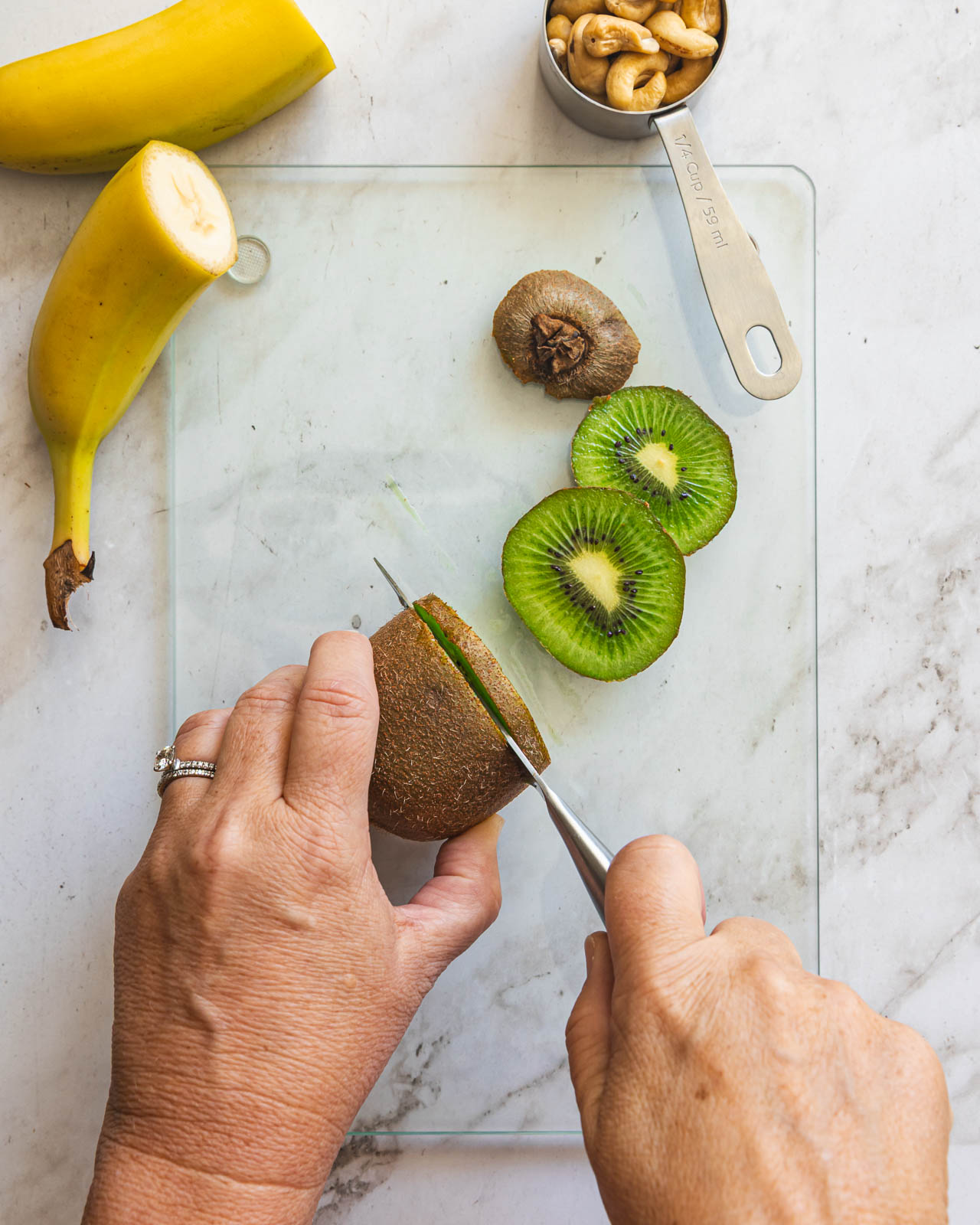 Slicing a kiwi for a fruit and nut snack plate