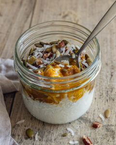 Pumpkin Greek Yogurt Bowl topped with pecans, pepitas and coconut