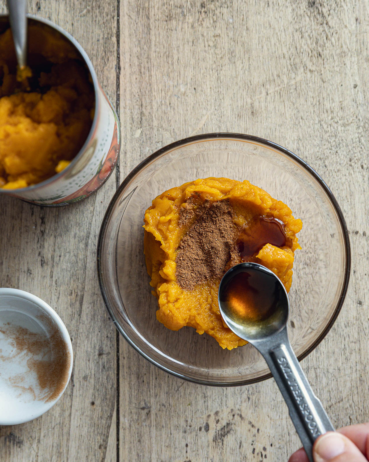 Adding maple syrup to pumpkin purée for a pumpkin yogurt bowl