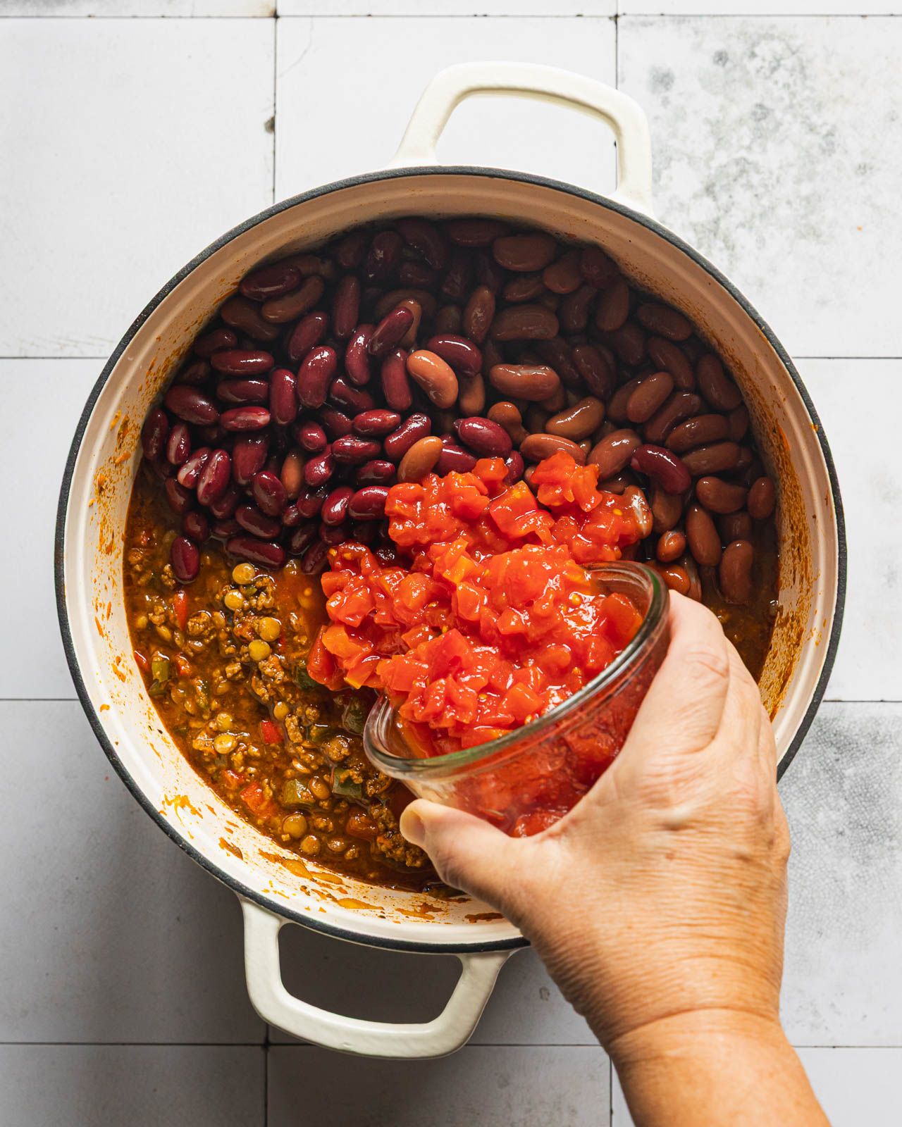 Adding diced tomatoes and kidney beans to beef lentil chili