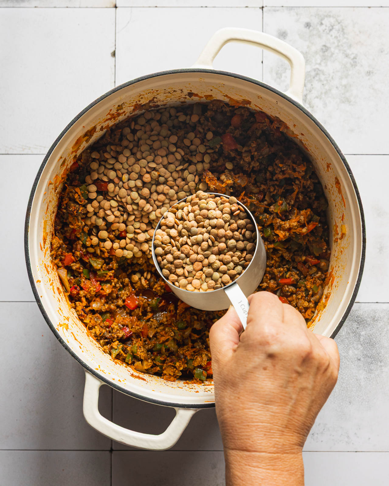 Adding dry brown lentils to ground beef and vegetables