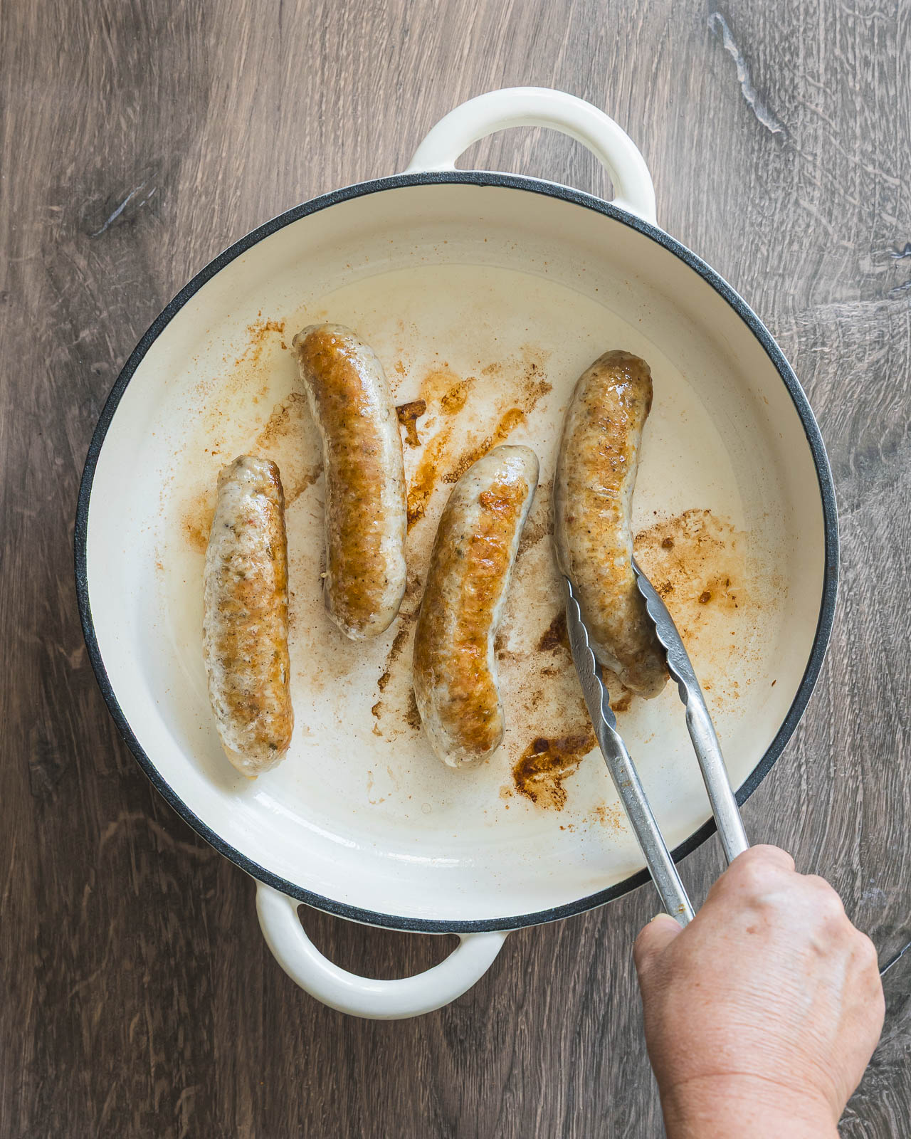 Italian chicken sausage links browning in a braiser
