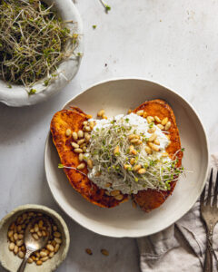 Caramelized sweet potatoes topped with cottage cheese, toasted pine nuts and microgreens