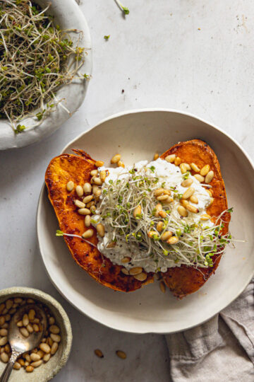 Caramelized sweet potatoes topped with cottage cheese, toasted pine nuts and microgreens