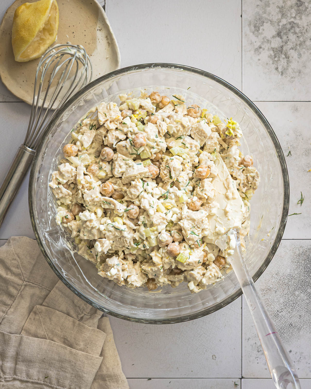 Finished creamy chicken and chickpea salad in a glass mixing bowl