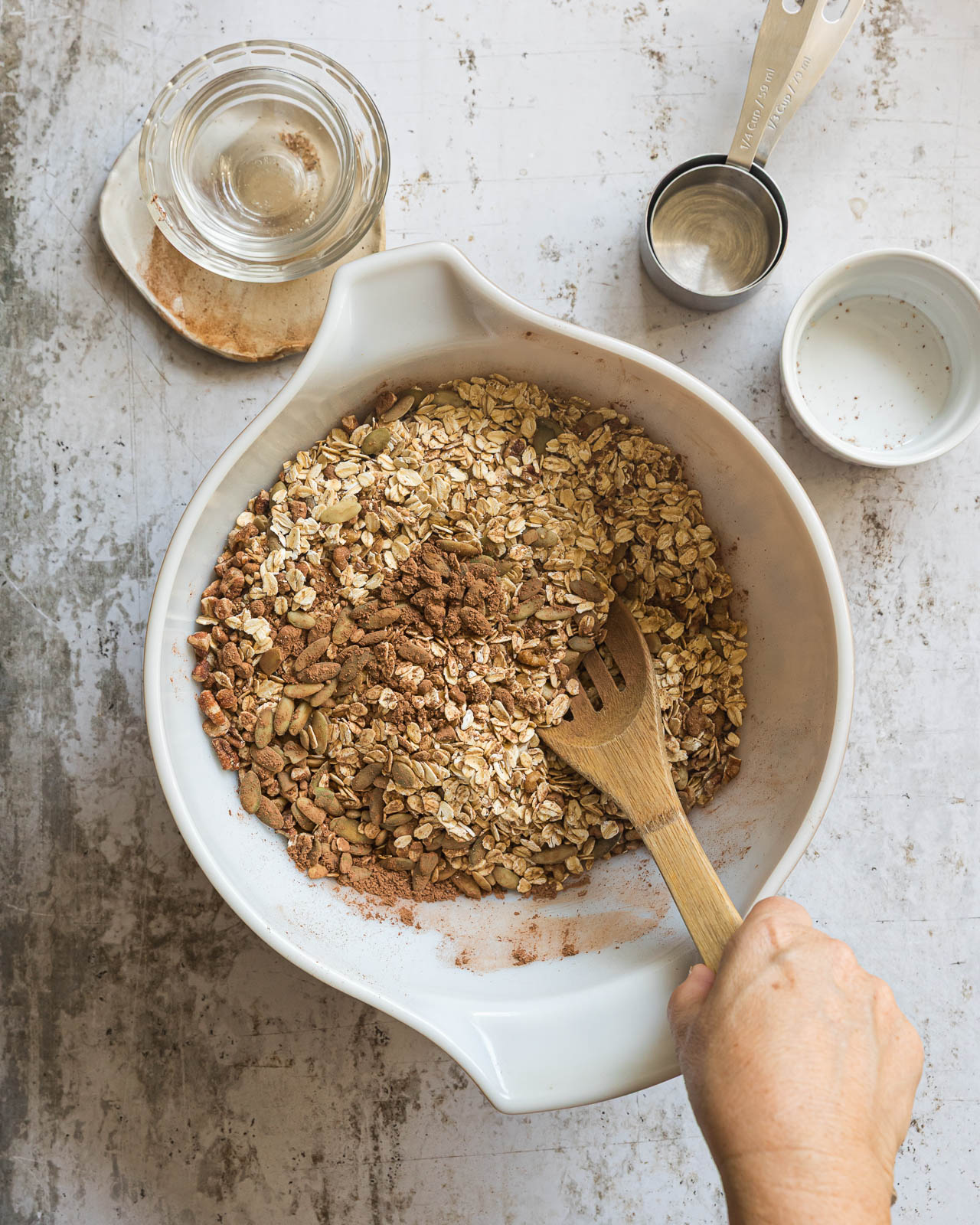 Dry ingredients being combined in a large bowl to make homemade chocolate granola